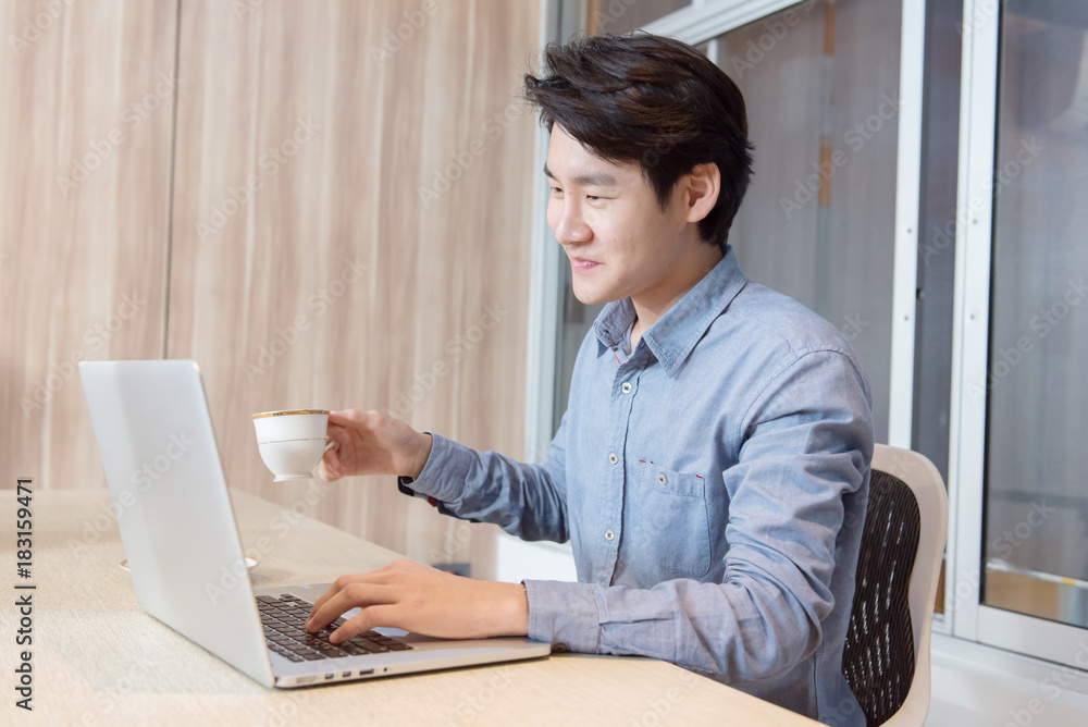 Businessman hand holding coffee cup and working in the Office with labtop Concept. Businessman hand holding coffee cup and working in the Office with labtop Concept.