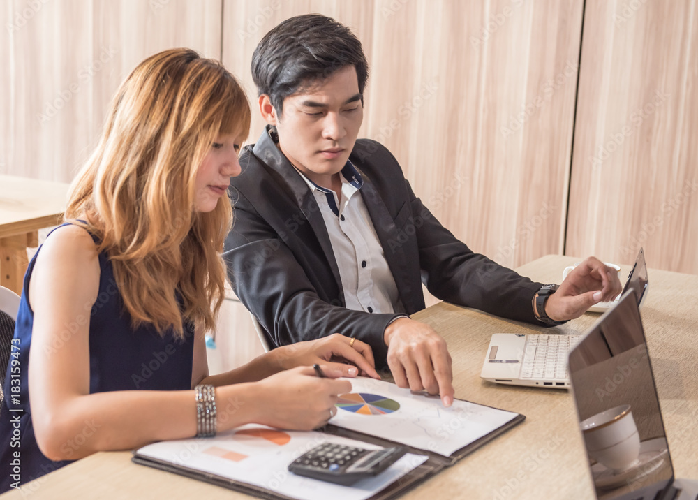 Businessman and Women Working in the Office with labtop and graphic document Concept. Businessman and Women Working in the Office with labtop and graphic document Concept.