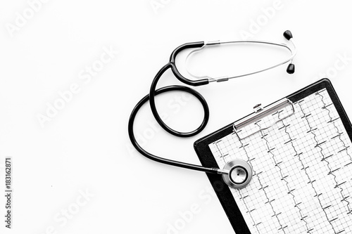 To diagnose heart disease. Cardiogram, stethoscope on white background top view copyspace photo