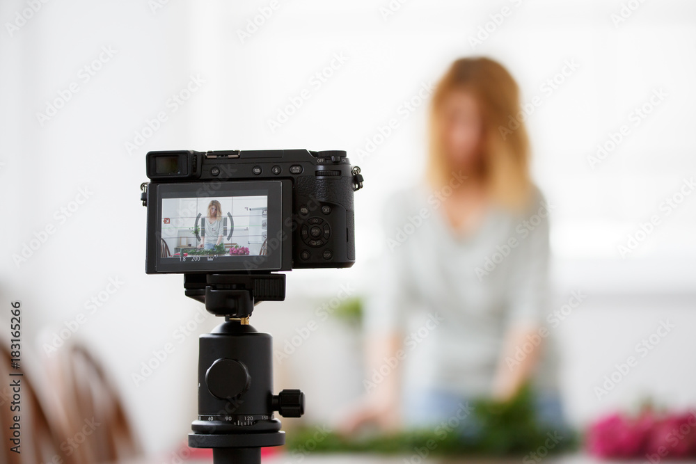 Blurred image of woman florist composing bouquet of pink flowers. Blurred image of woman florist composing bouquet of pink flowers.