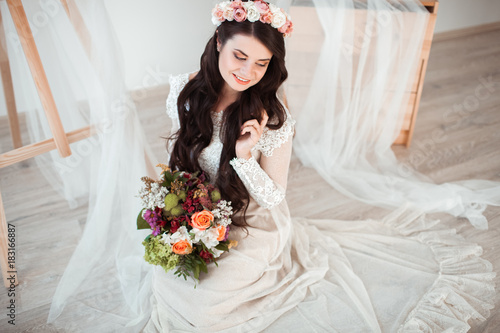 Beautiful bride with wedding bouquet on white background