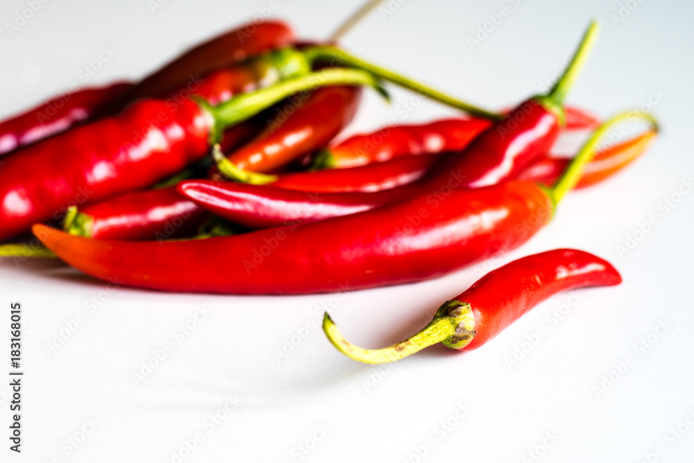 Red hot peppers fresh on the kitchen table. White background. Red hot peppers fresh on the kitchen table. White background.