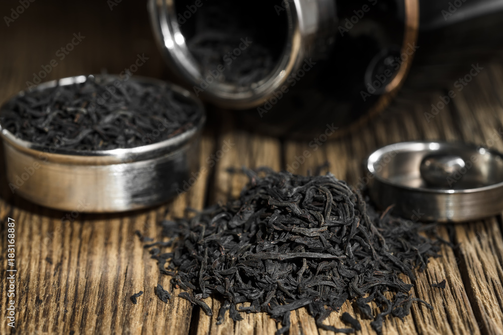 Black tea big leaf on the old wooden rustic table Black tea big leaf on the old wooden rustic table
