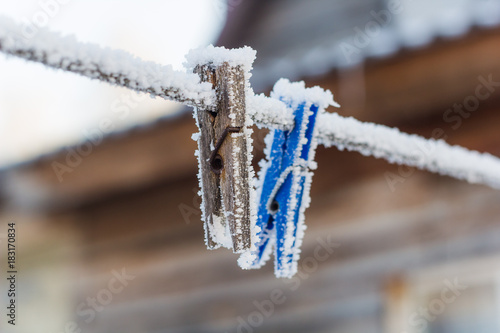 clothespin   covered with snow blurred background