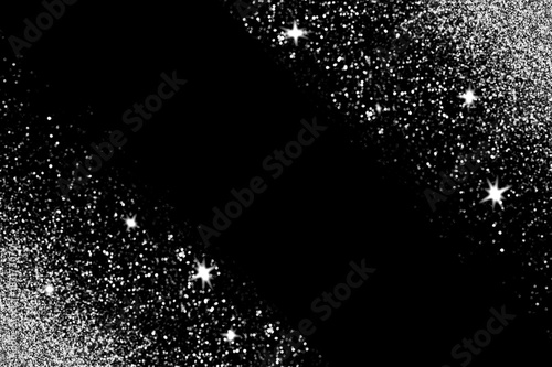 Silver glitter with glowing sparks on black background