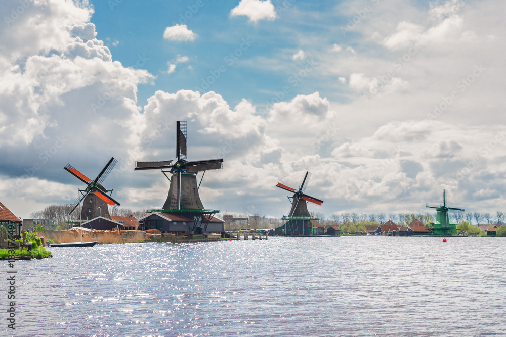 Dutch scenery with windmill of Zaanse Schans over Zaan river at summer day, Netherlands