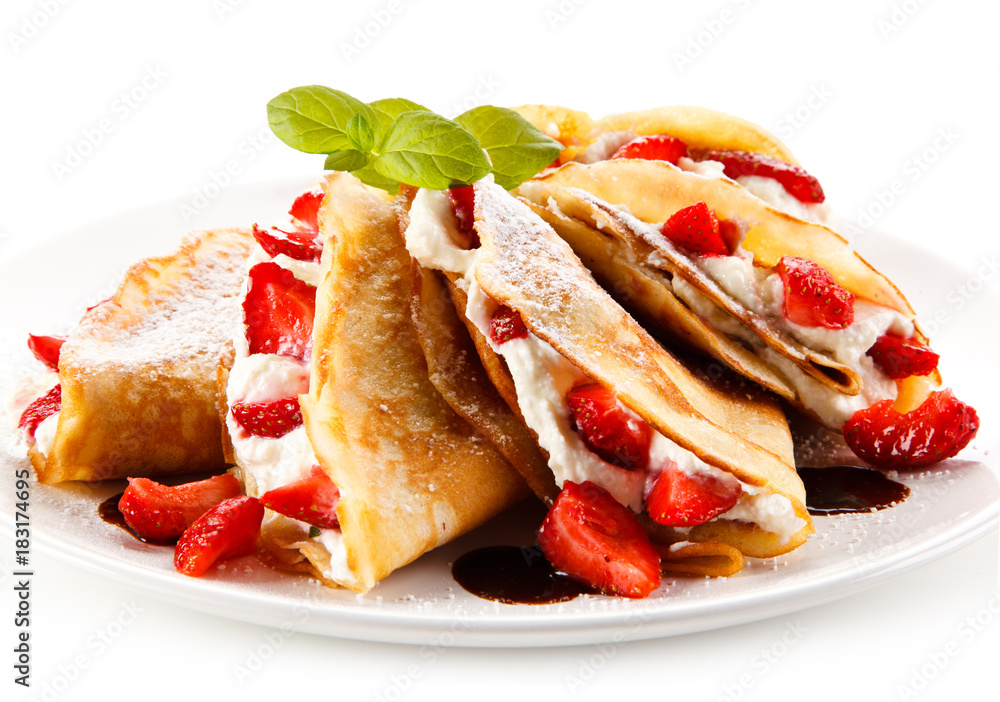 Crepes with strawberries and cream on white background Crepes with strawberries and cream on white background