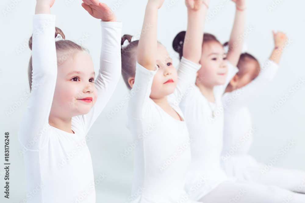 Obraz premium Group of little girls are practicing at school of the ballet