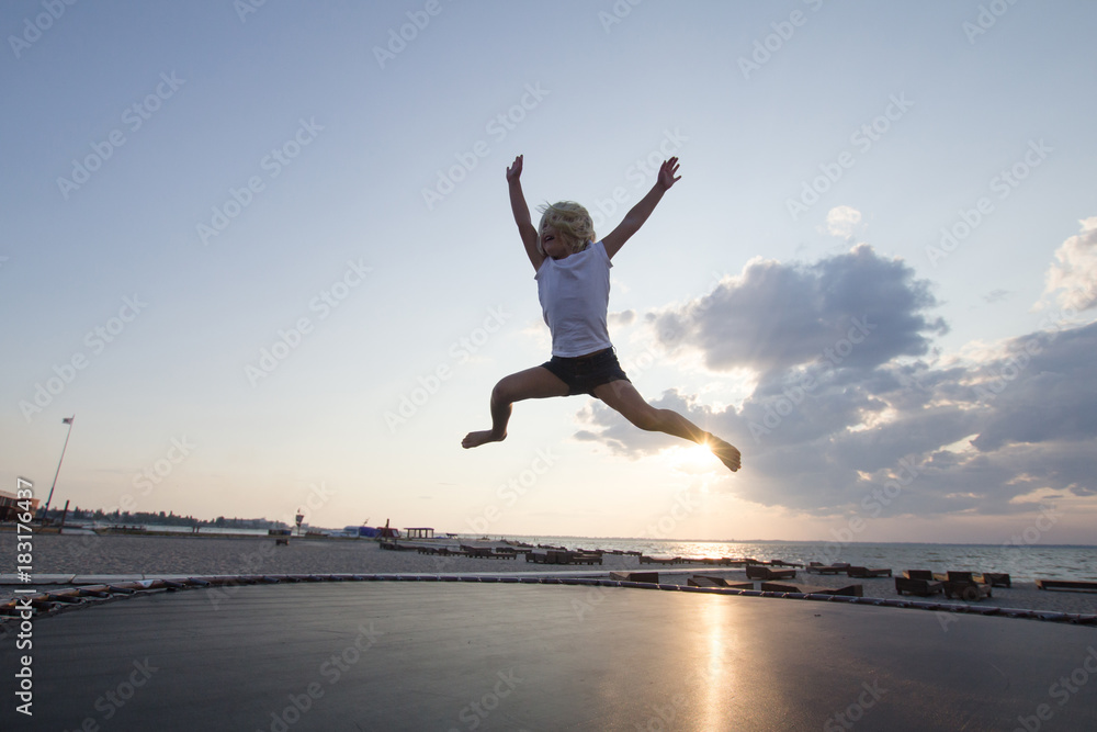 little girl jump and having good time on trampoline in summer time little girl jump and having good time on trampoline in summer time