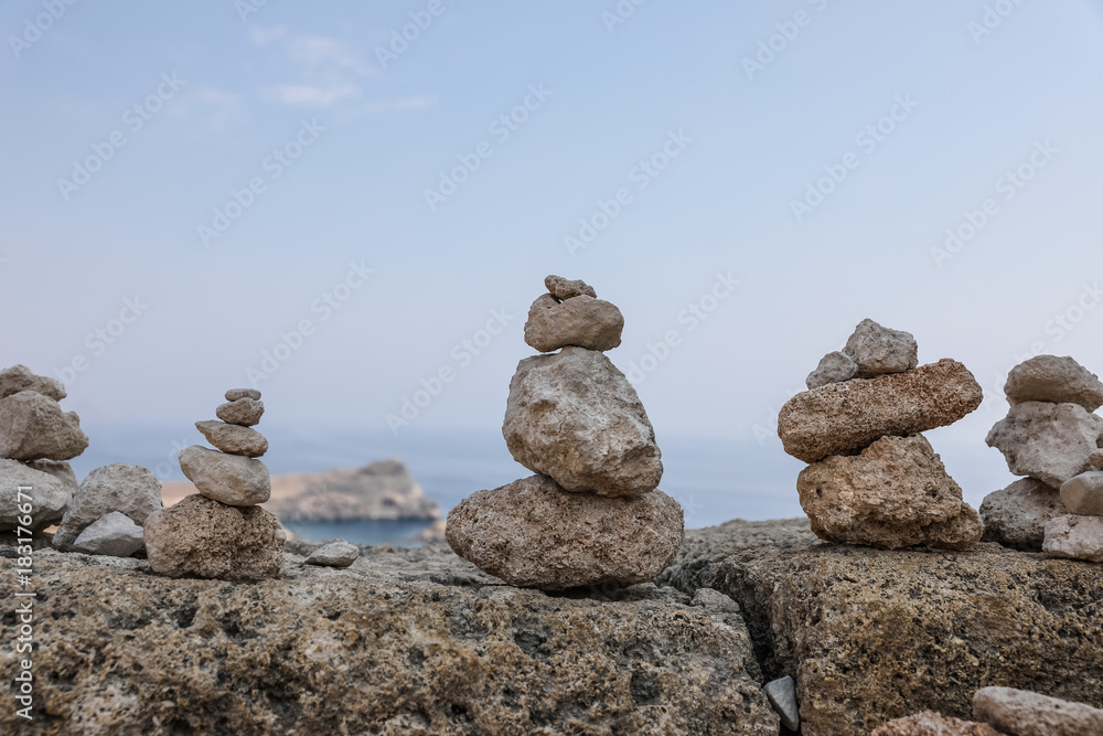 Landscape with small piles of rocks left there by the visitors as a form of a memento. On the Rhodes Island, Greece Landscape with small piles of rocks left there by the visitors as a form of a memento. On the Rhodes Island, Greece
