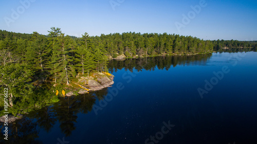 Aerial view of camping on the edge of a river during a family canoe trip
