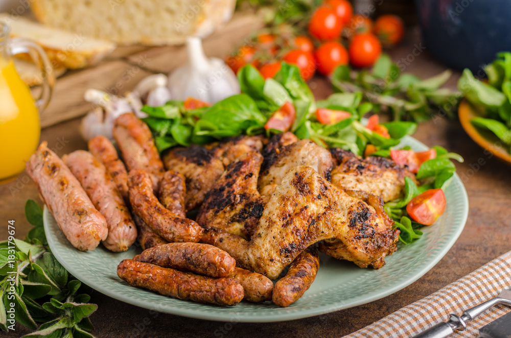 Grilled chicken wings and sausages