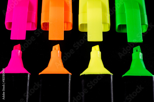 Office Highlighter on a black background. Office Mazak to draw are lying on a black countertop. photo