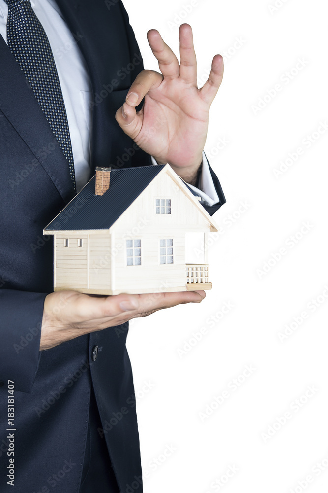 Hand of the businessman with the house Hand of the businessman with the house