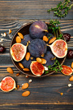 Figs and nuts on wooden background