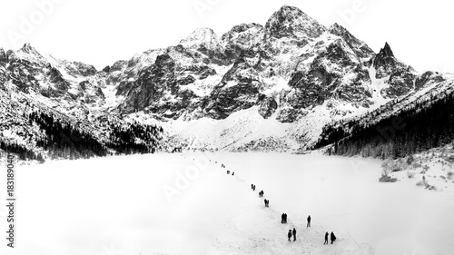 Black and white winter landscape of frozen Morskie Oko Lake and snowy Tatra Mountains in Lesser Poland.