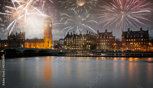 explosive fireworks display fills the sky around Big Ben. New Year's Eve celebration in the city