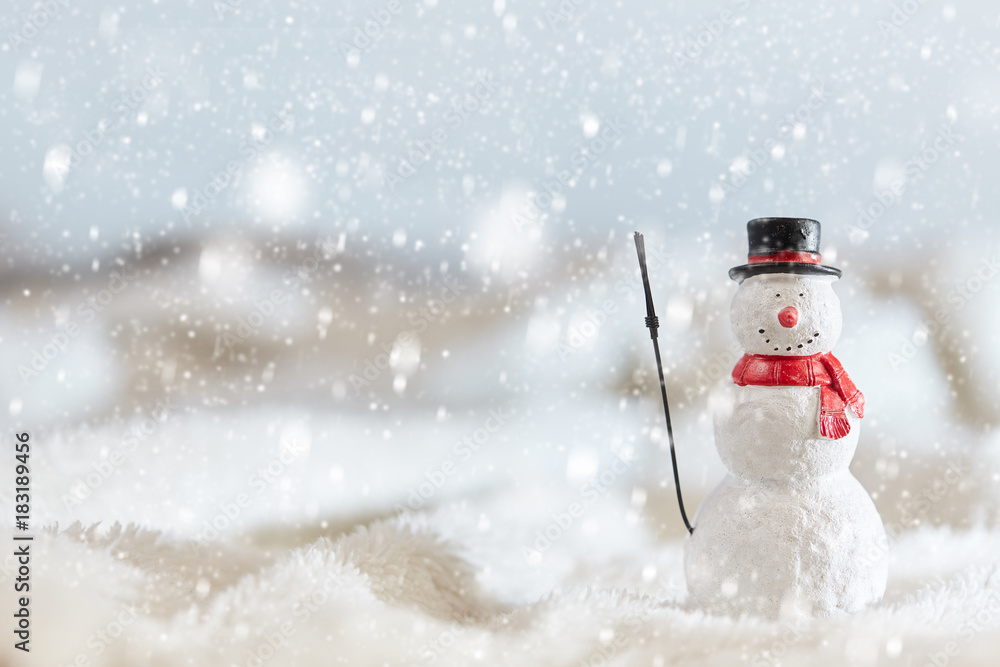 Snowman wiht snow flakes in winter landscape