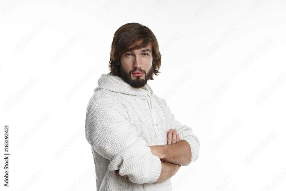 Picture of arrogant conceited young unshaven male keeping arms folded on his chest and staring at camera with suspicious distrustful look, doesn't believe his unfaithful wife who is cheated on him Picture of arrogant conceited young unshaven male keeping arms folded on his chest and staring at camera with suspicious distrustful look, doesn't believe his unfaithful wife who is cheated on him
