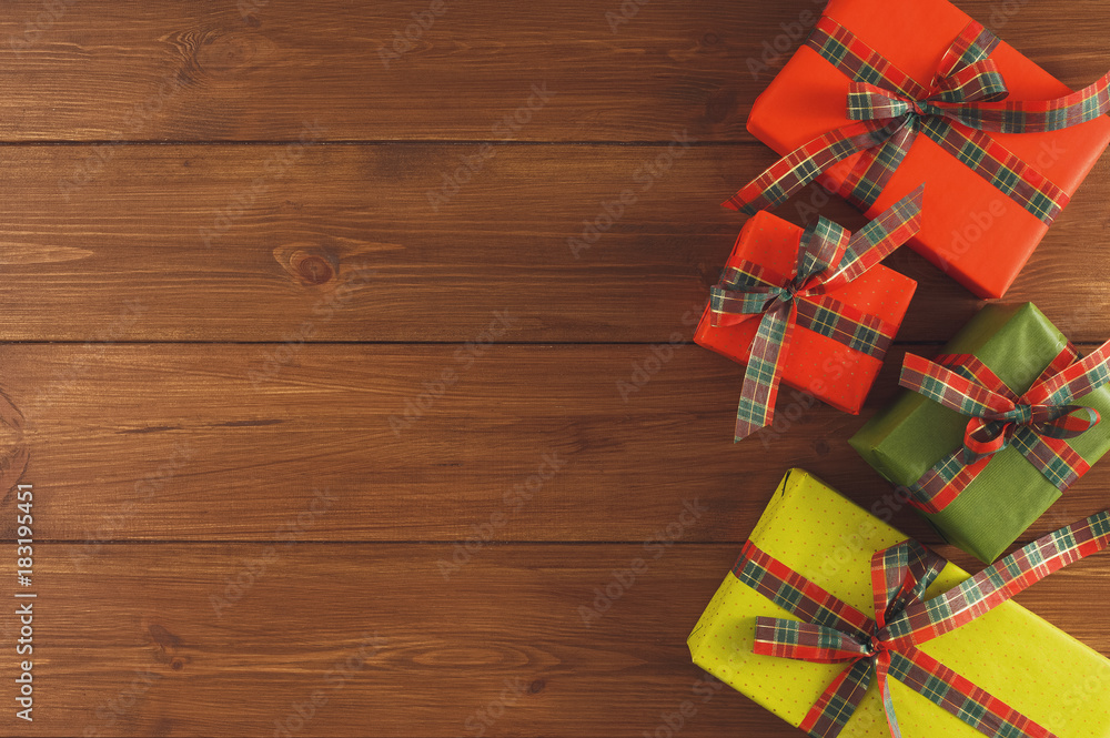 Christmas gift boxes, top view on wood table background. Christmas gift boxes, top view on wood table background.