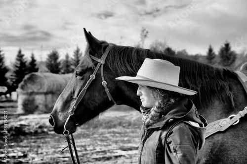 close up of a woman and a horse in black and white photo