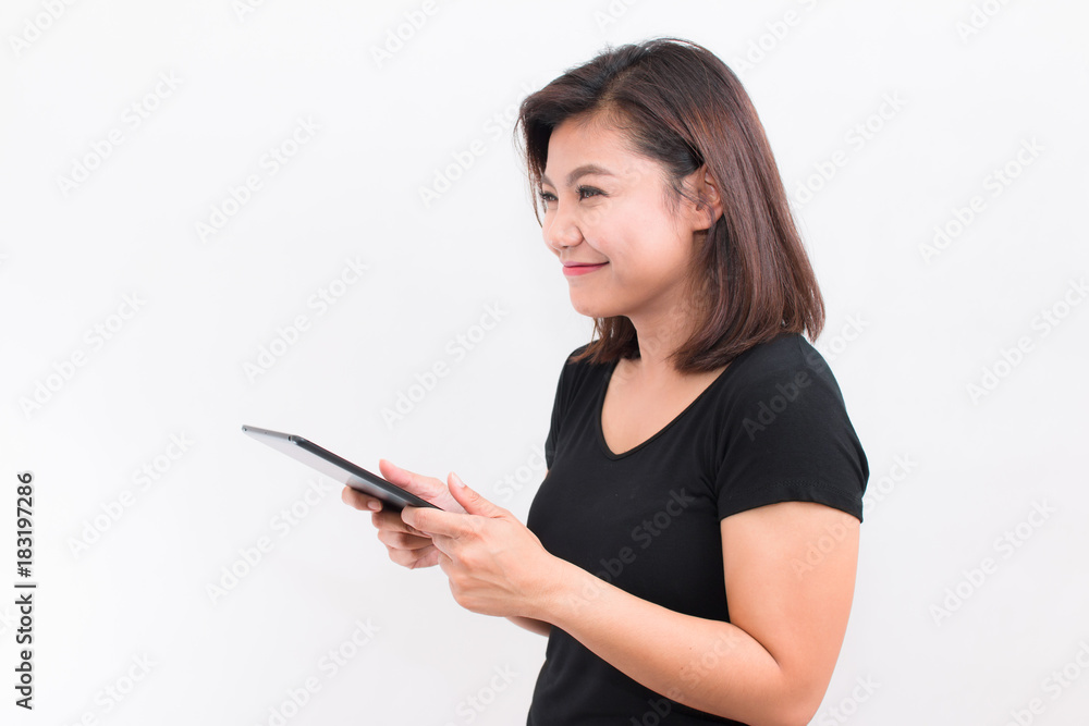 Beautiful Asian woman holding tablet. her looked at tablet and have happy smile on white background. Beautiful Asian woman holding tablet. her looked at tablet and have happy smile on white background.