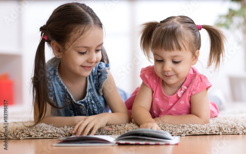Child girl reading book wit...