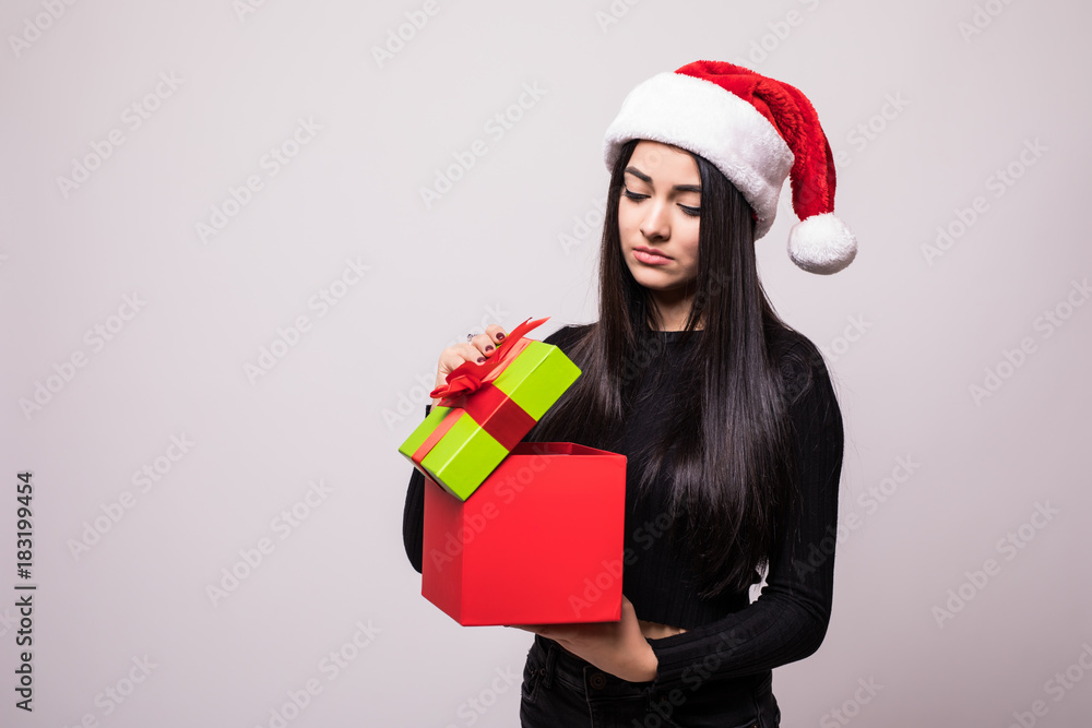 Christmas Woman open Gift Box. Beautiful Brunette Girl in Santa Hat isolated. Portrait Christmas Woman open Gift Box. Beautiful Brunette Girl in Santa Hat isolated. Portrait