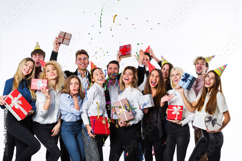 Holiday. Young beautiful people having fun on a white background.