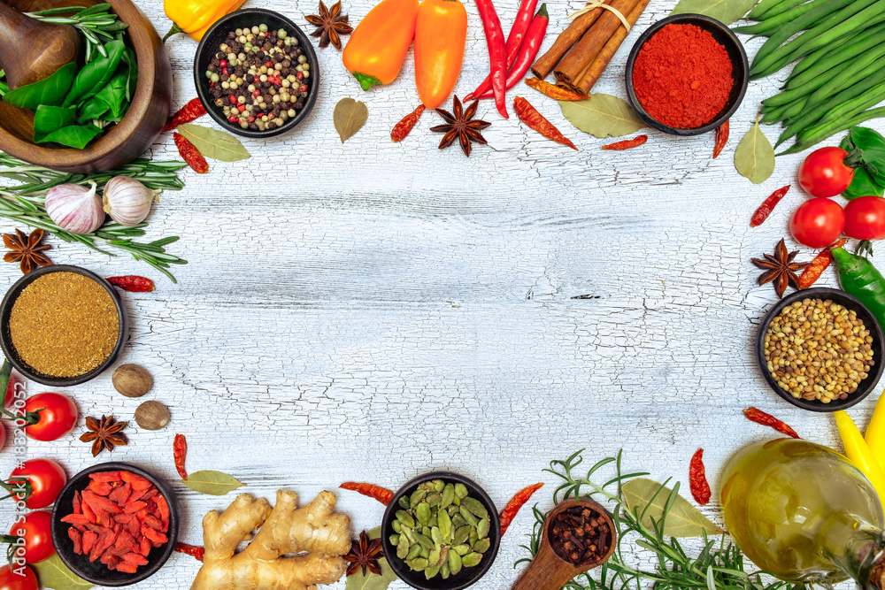 Spices and herbs on white wooden background
