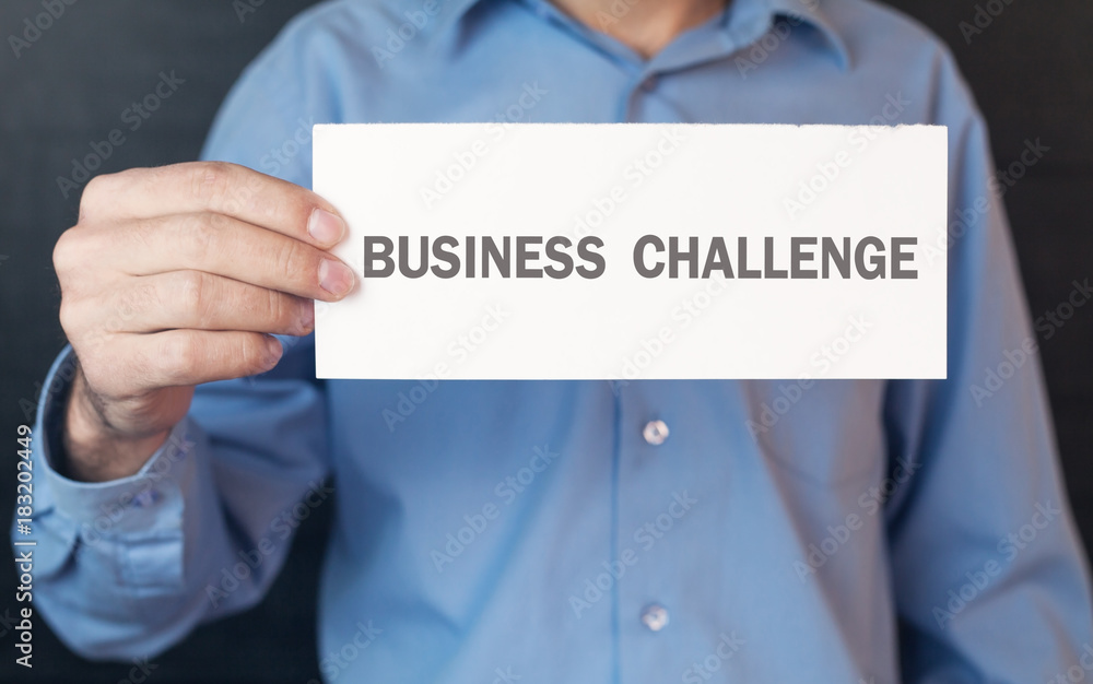 Man showing white paper with a business challenge word. Man showing white paper with a business challenge word.