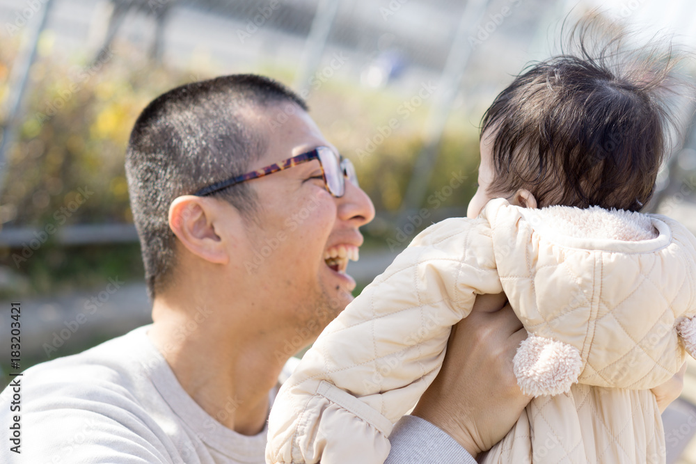 Fototapeta premium A Japanese man holding a child