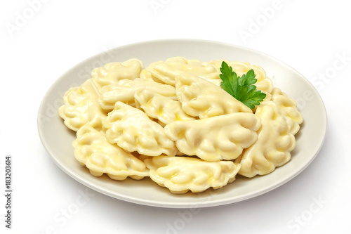 Meat dumplings - russian pelmeni, ravioli with meat on a plate on a white background, isolated