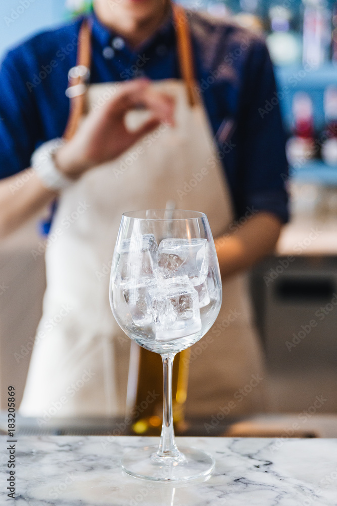 Wine glass with ice inside that ready for making cocktail.