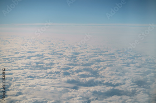 Fototapeta Naklejka Na Ścianę i Meble -  aerial shot from plane flying above the clouds in daytime