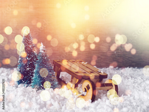 Christmas concept, toy santa sleigh, gift boxes on snow and blur bokeh, Empty wooden sled