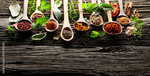 Herbs and spices on wooden background