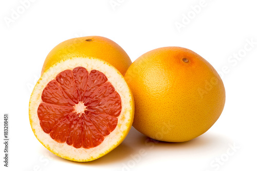 Ripe grapefruit and half on white