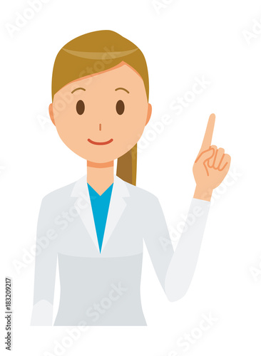 A female doctor wearing a white coat is pointing