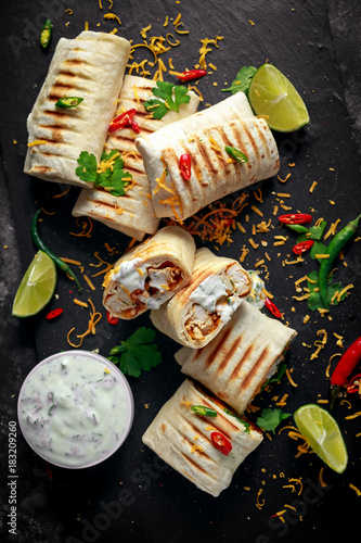 Obraz na plátně Healthy grilled chicken and parsley wraps, loaded with cheese, served with greek
