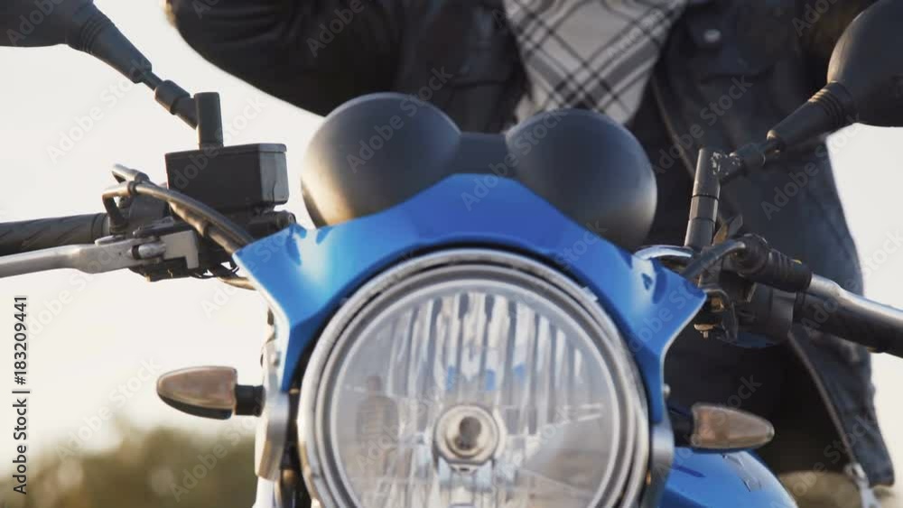 The biker undresses helmet and put it on a motocycle. 4K The biker undresses helmet and put it on a motocycle. 4K