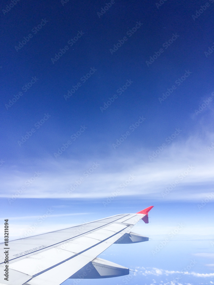 Fototapeta premium Morning blue sky with Wing of an airplane.