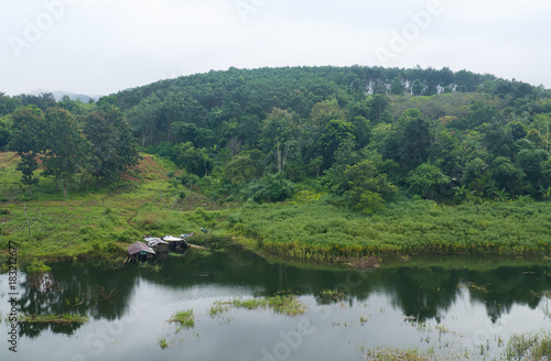 Landscape of river and green forest mountain with wooden house at Kanchanaburi, Thailand