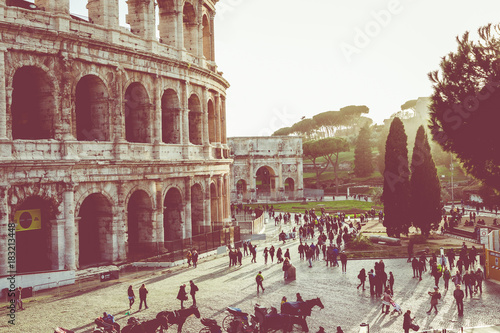 Rome, Italy.One of the most popular travel place in world - Roman Coliseum under evening sun light and sunrise sky. photo