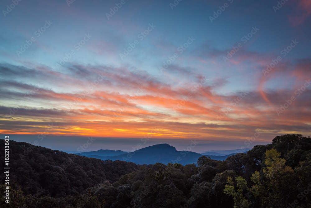 Beautiful sunrise sky and mist green mountain scenery, Doi Intanon ,Thailand with orange clouds