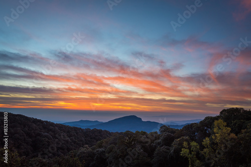 Beautiful sunrise sky and mist green mountain scenery, Doi Intanon ,Thailand with orange clouds