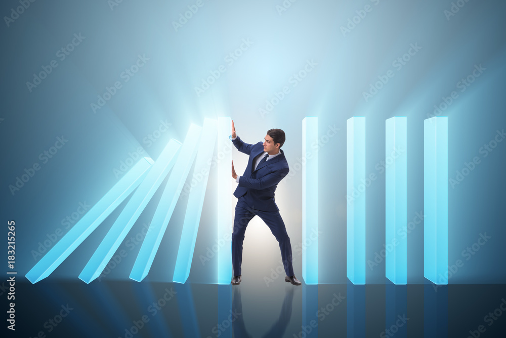 Fototapeta premium Businessman in domino effect business concept
