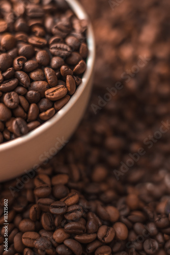 Ceramic cup filled with coffee beans close up. Beverages menu design. Place for text.