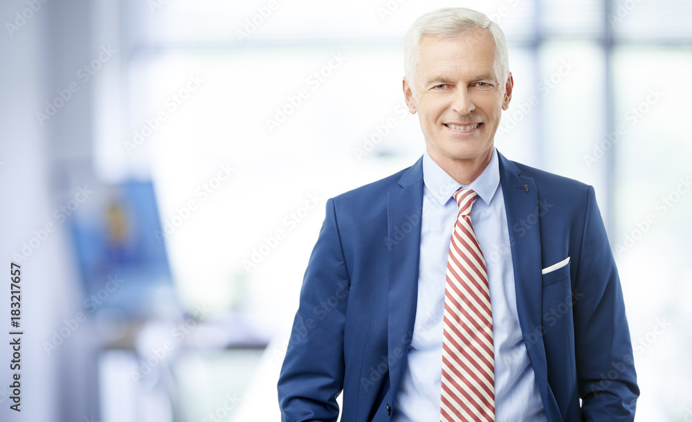 Financial business man. A senior financial consultant businessman standing in shirt and tie in his office. Financial business man. A senior financial consultant businessman standing in shirt and tie in his office.