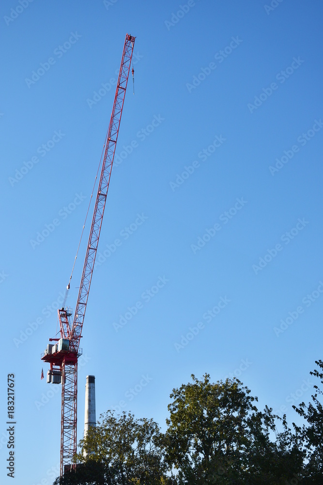 Construction cranes against a blue sky background Construction cranes against a blue sky background